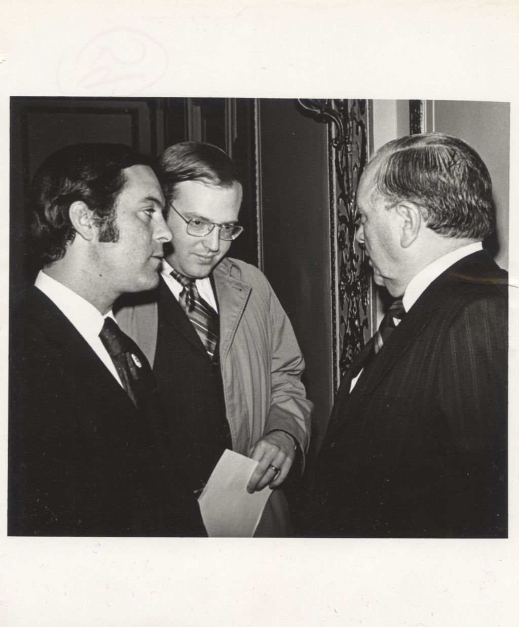 Miniature of Richard J. Daley speaking with two men at a "We Care" event