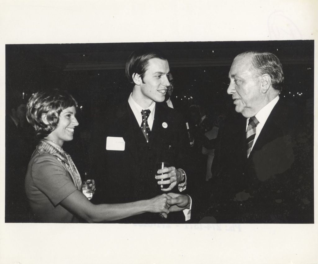 Miniature of Richard J. Daley shaking hands at a "We Care" event