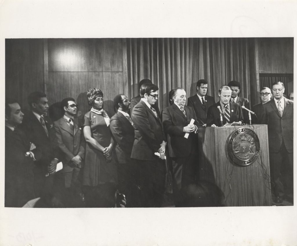 Richard J. Daley speaking at a City of Chicago podium at a "We Care" event