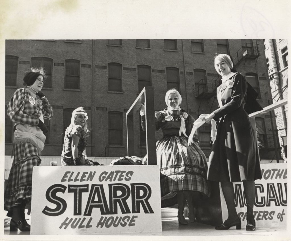 Four women next to an "Ellen Gates Starr Hull House" sign at a "We Care" event