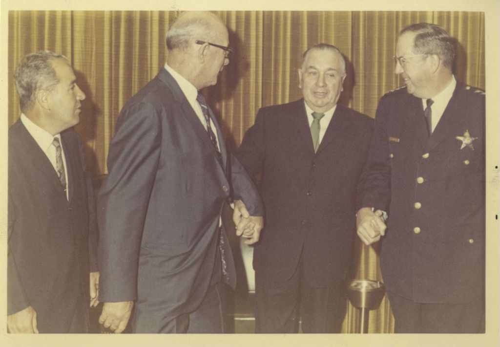 Miniature of Richard J. Daley with three men at a reception