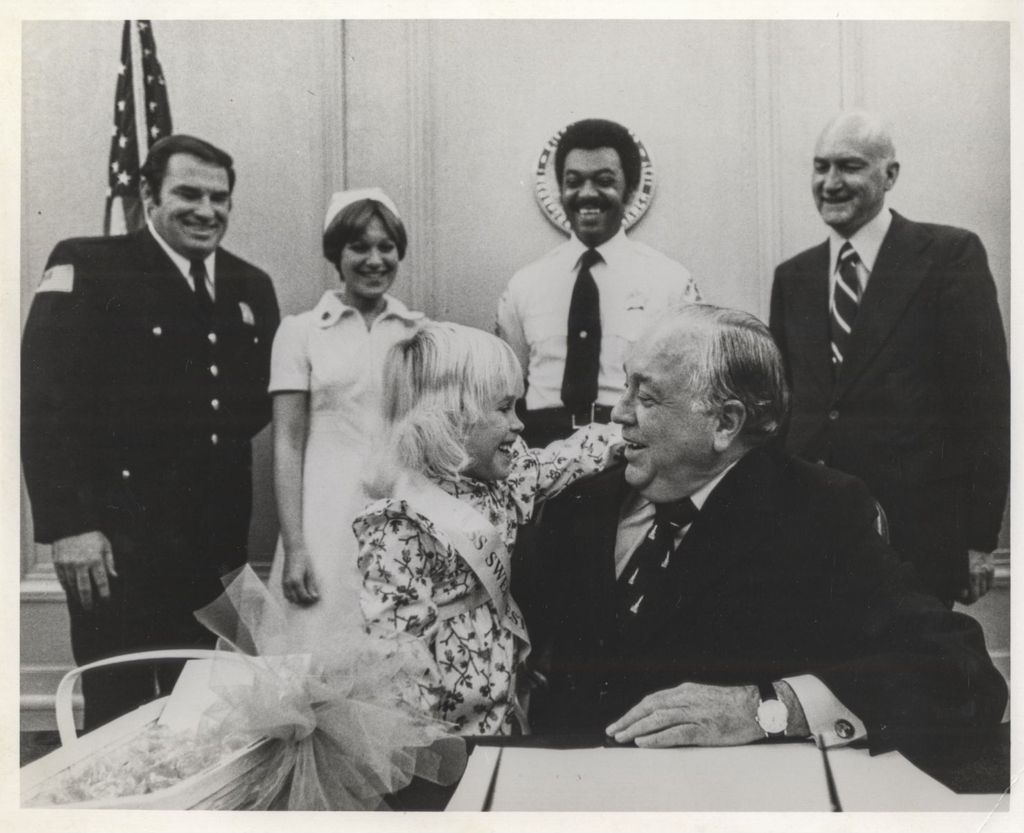 Miniature of Richard J. Daley receives a hug from "Miss Sweetest Day"