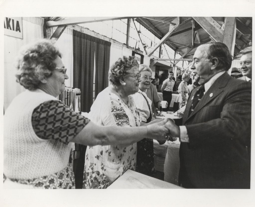 Richard J. Daley greeting woman at a Holiday Folk Fair