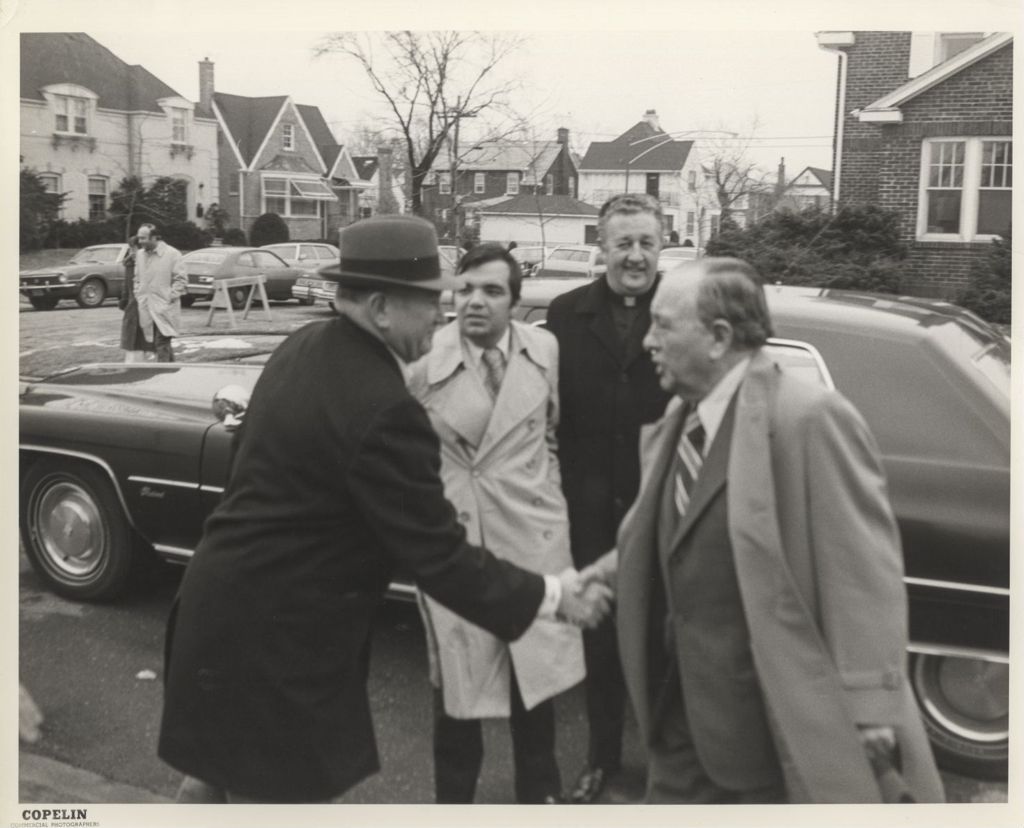 Richard J. Daley greets a man outside on a street