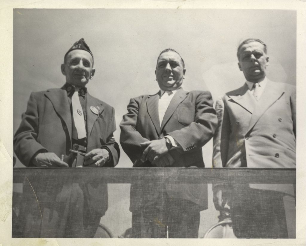 Richard J. Daley on a dais with two men