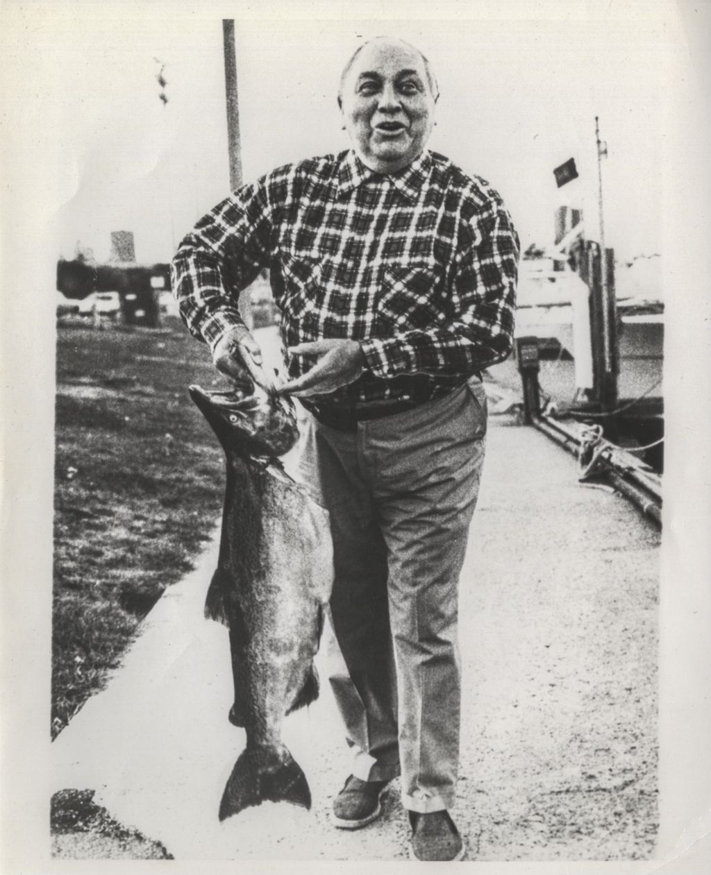 Richard J. Daley holding a coho salmon
