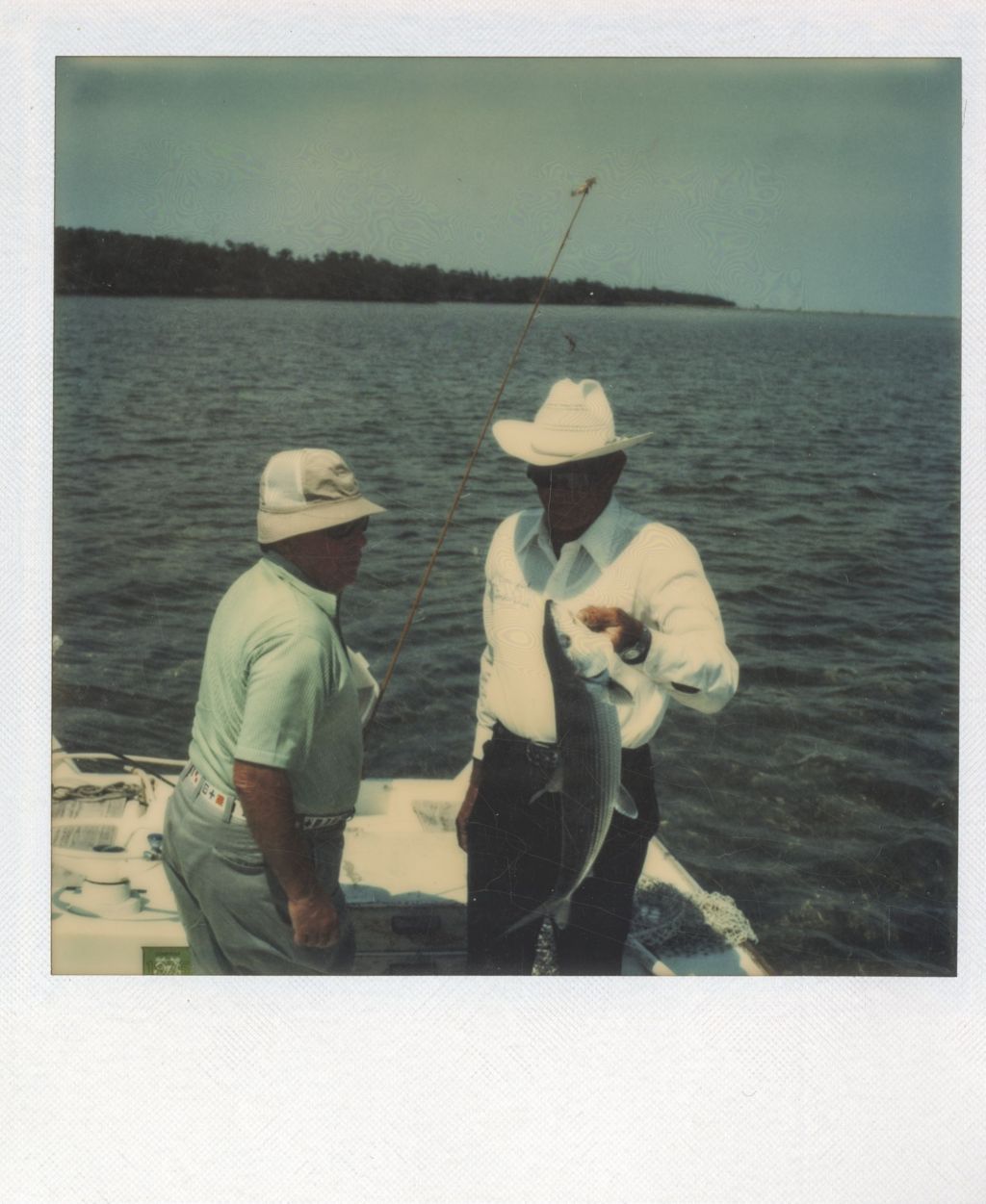 Richard J. Daley and a man displaying a fish