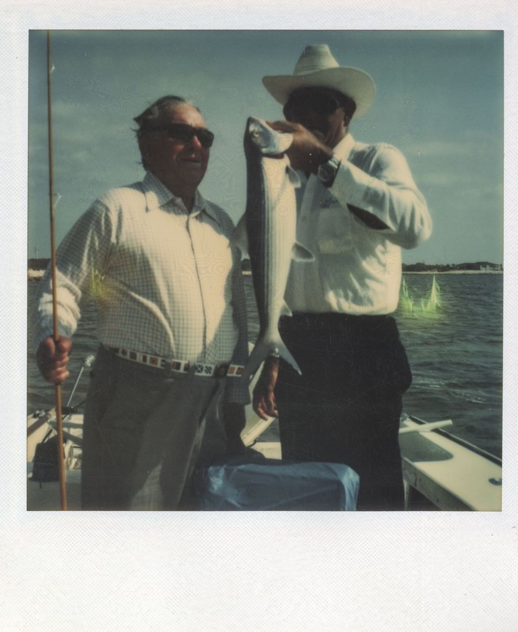 Richard J. Daley and a man displaying a fish
