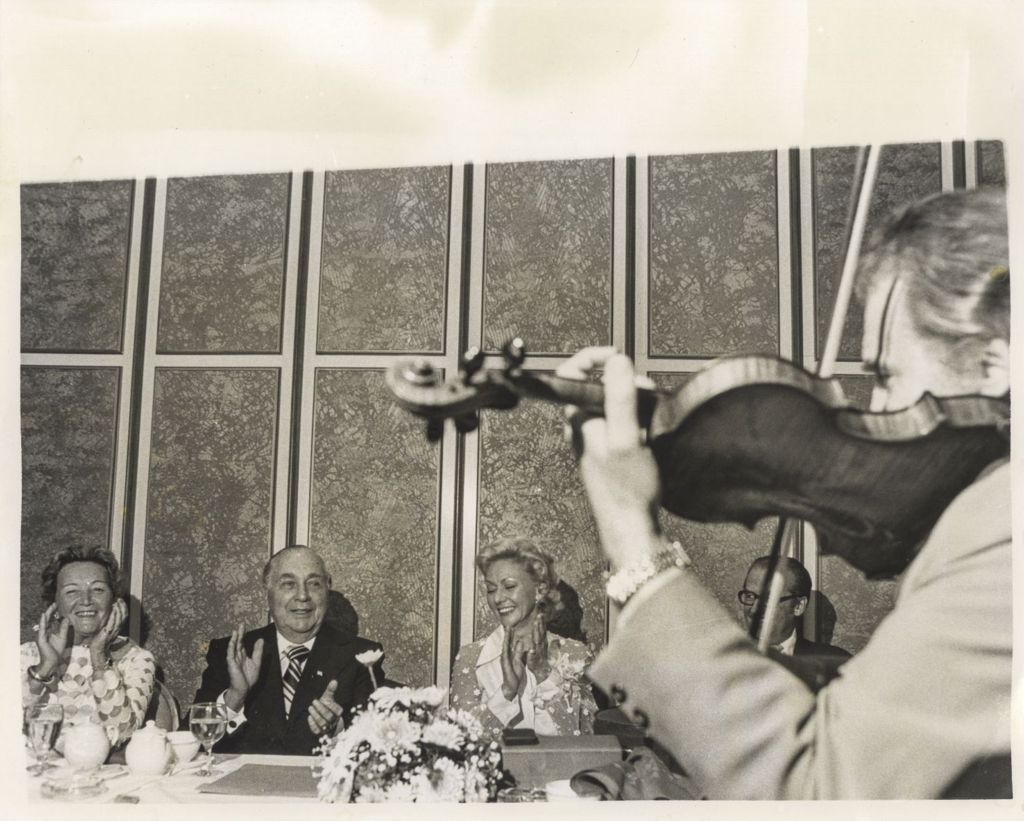 Miniature of Eleanor Daley and Richard J. Daley applaud a violinist's performance
