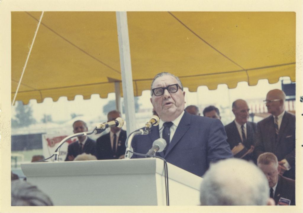 Miniature of Richard J. Daley speaking outdoors under an awning