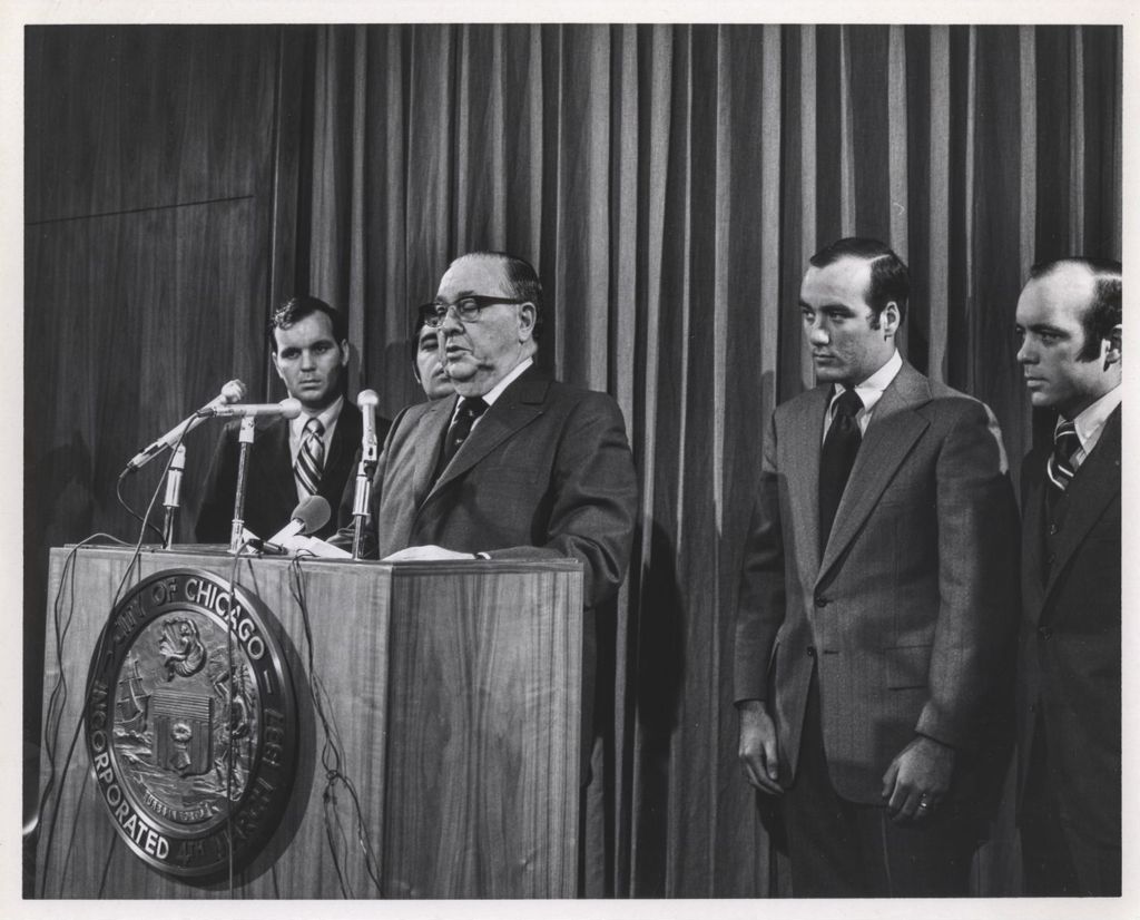 Miniature of Richard J. Daley speaking at a podium accompanied by his sons
