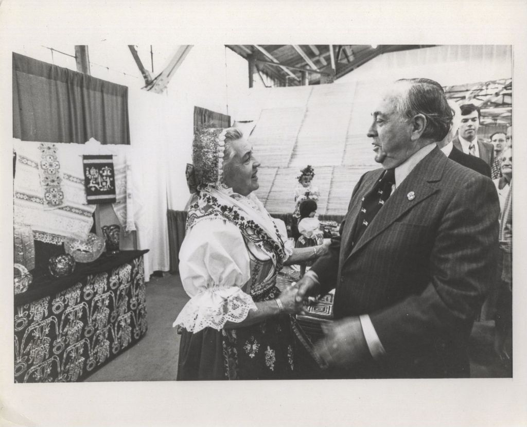 Miniature of Richard J. Daley greets a woman at a Holiday Folk Fair