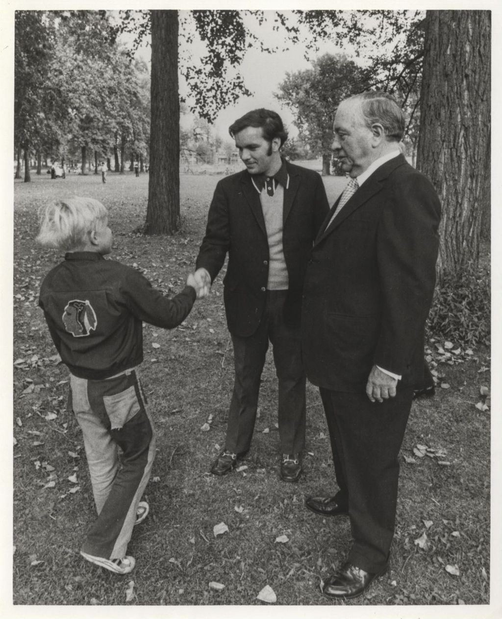 Richard M. Daley greets a young boy as Richard J. Daley looks on