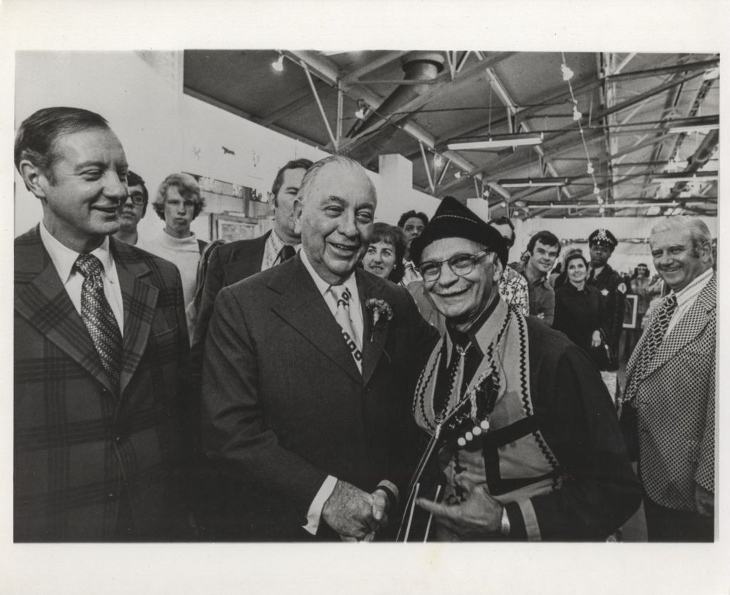 Richard J. Daley shakes hands with a musician