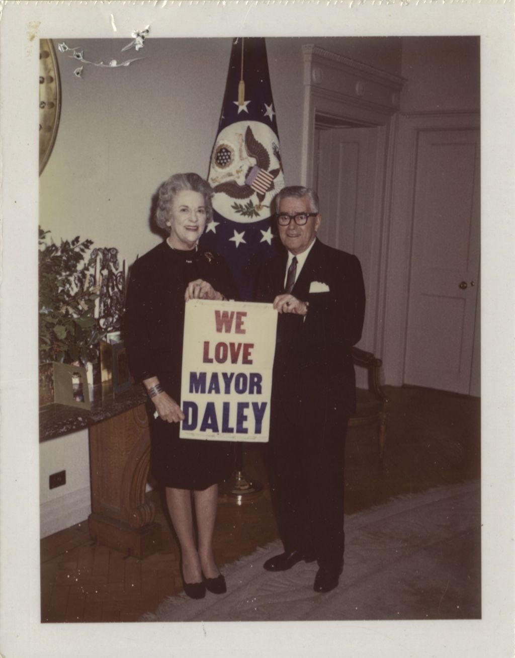 Leo J. Sheridan and Bea Sheridan with a "We Love Mayor Daley" poster