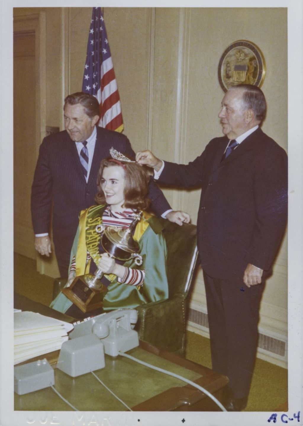 Richard J. Daley with a St. Patrick's Day Queen in his office chair