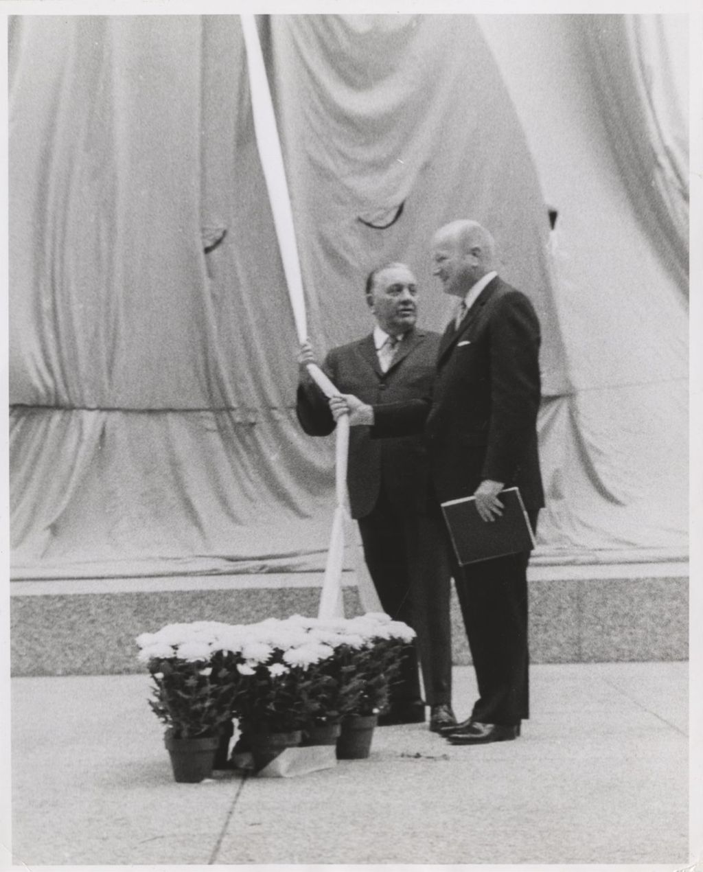 Picasso sculpture dedication ceremony, Richard J. Daley and William E. Hartmann about to unveil the sculpture