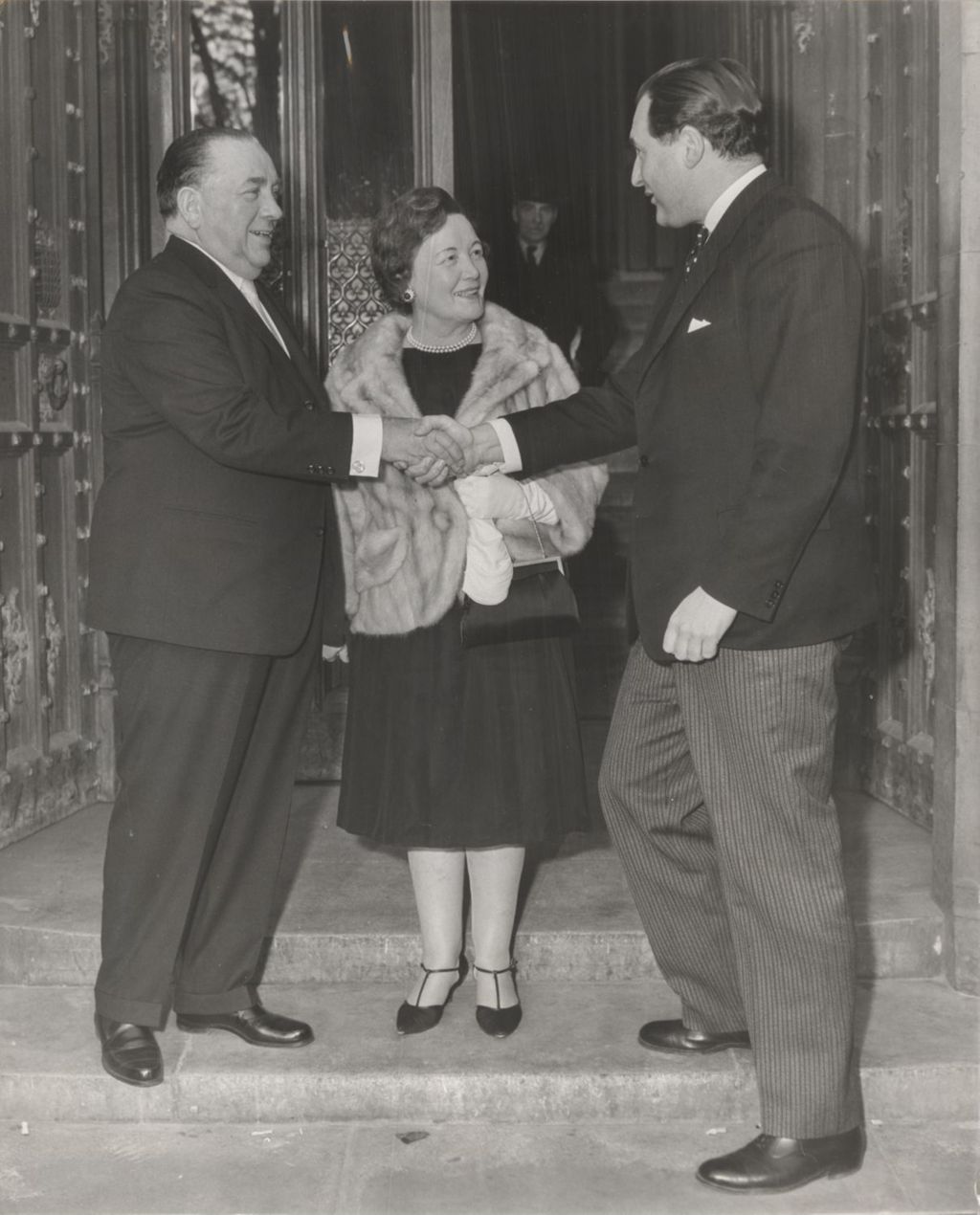 Miniature of Richard J. and Eleanor Daley greet a member of Parliament at the House of Commons in London
