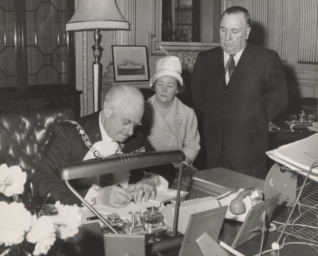 Miniature of Lord Mayor of London Clement Harman autographing a book for Eleanor and Richard J. Daley