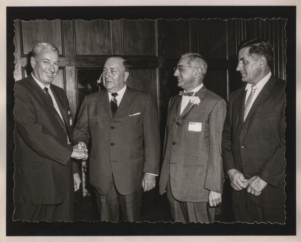 Miniature of Friendship Banquet photo album, Richard J. Daley shakes hands with a man