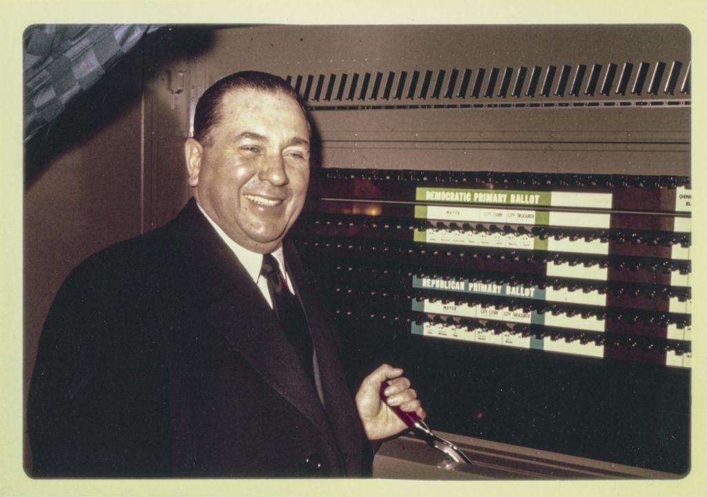 Primary election day, Richard J. Daley holds the lever in a voting booth