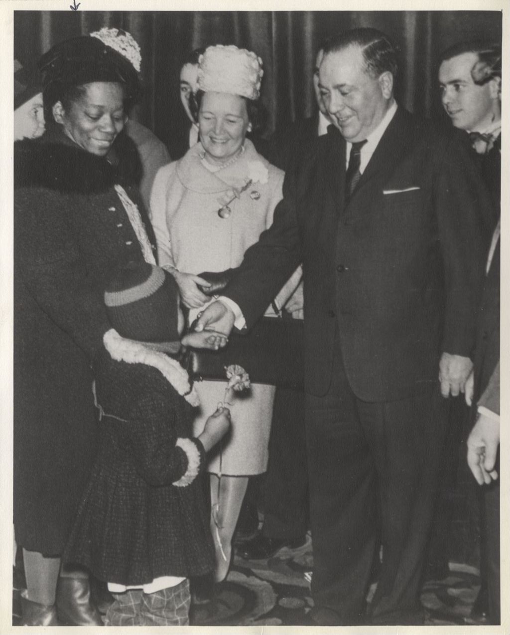 Richard J. Daley greets Attorney Lucia Theodosia Thomas and a young girl