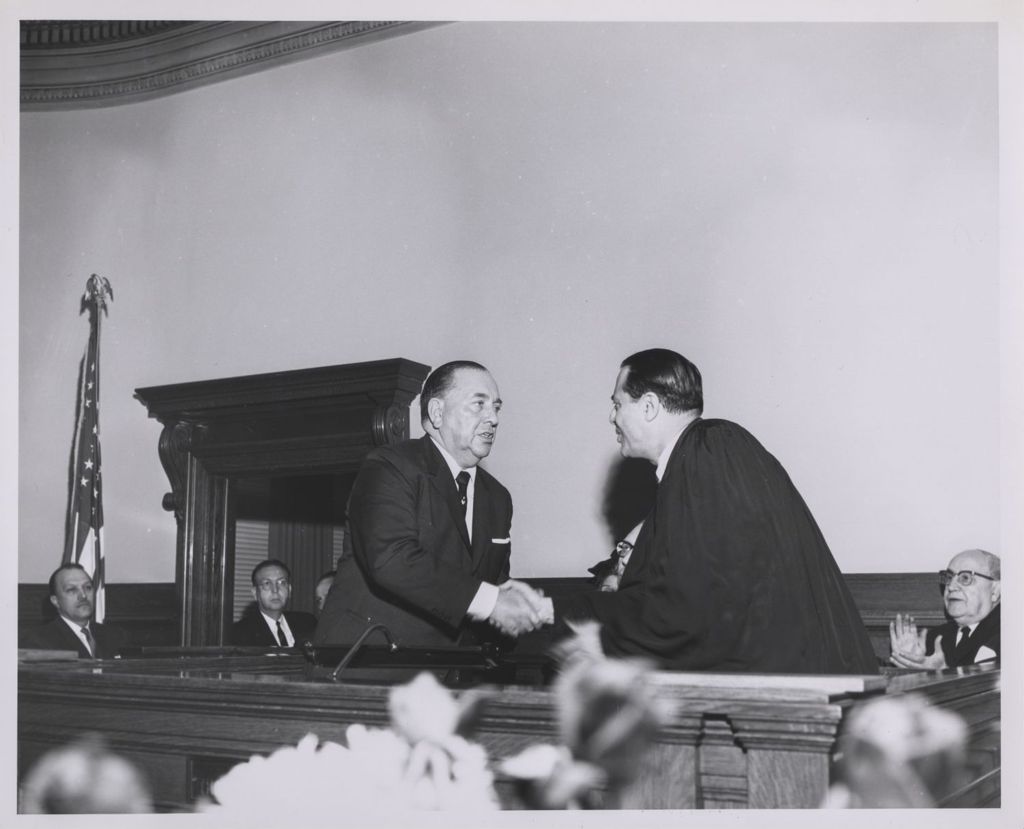 Judge's induction ceremony, Richard J. Daley shakes hands with inducted judge