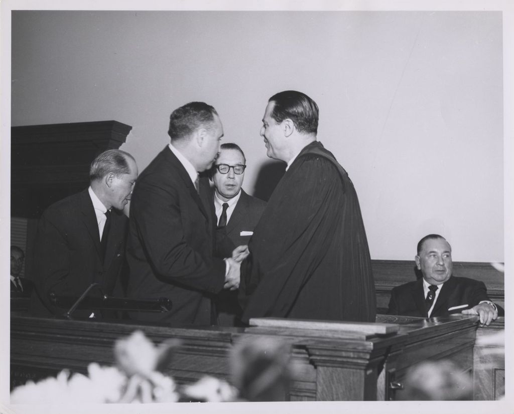 Miniature of Judge's induction ceremony in courtroom