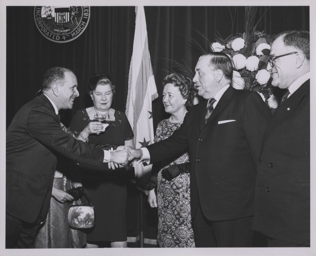 Miniature of Consular Corps Reception, Richard J. Daley shakes hands with a man