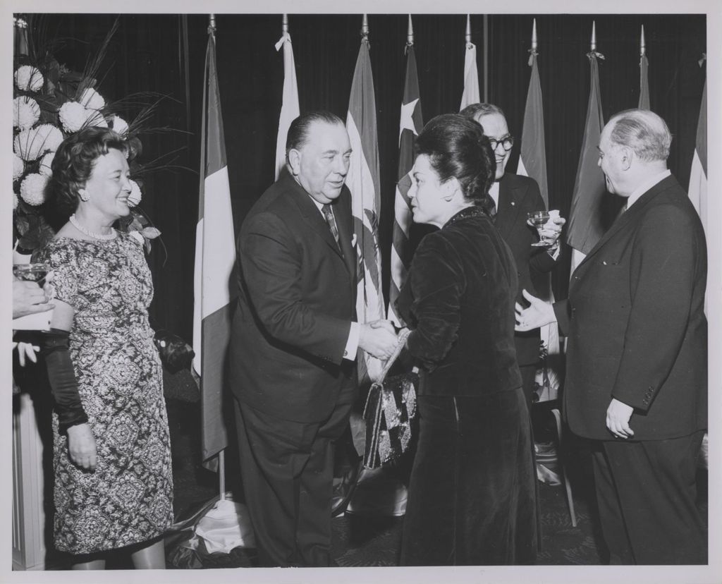 Consular Corps Reception, Richard J. Daley shakes hands with a woman