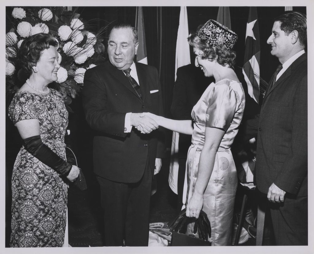 Consular Corps Reception, Richard J. Daley shakes hands with a woman