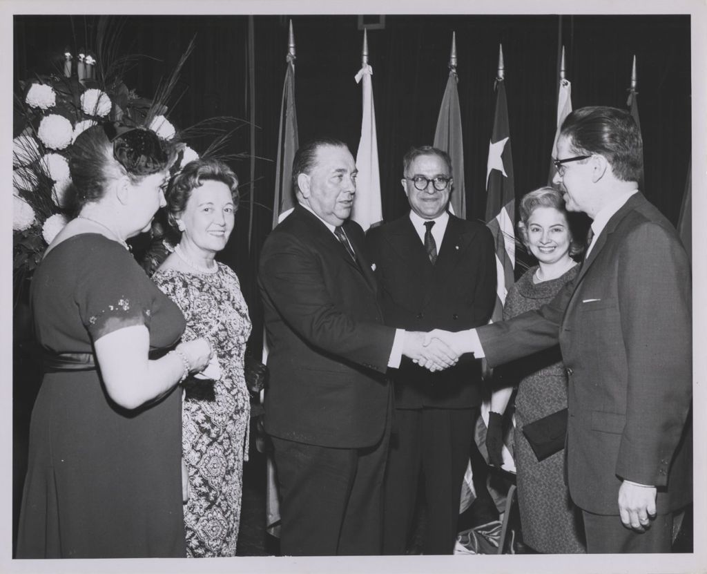 Miniature of Consular Corps Reception, Richard J. Daley shakes hands with a man
