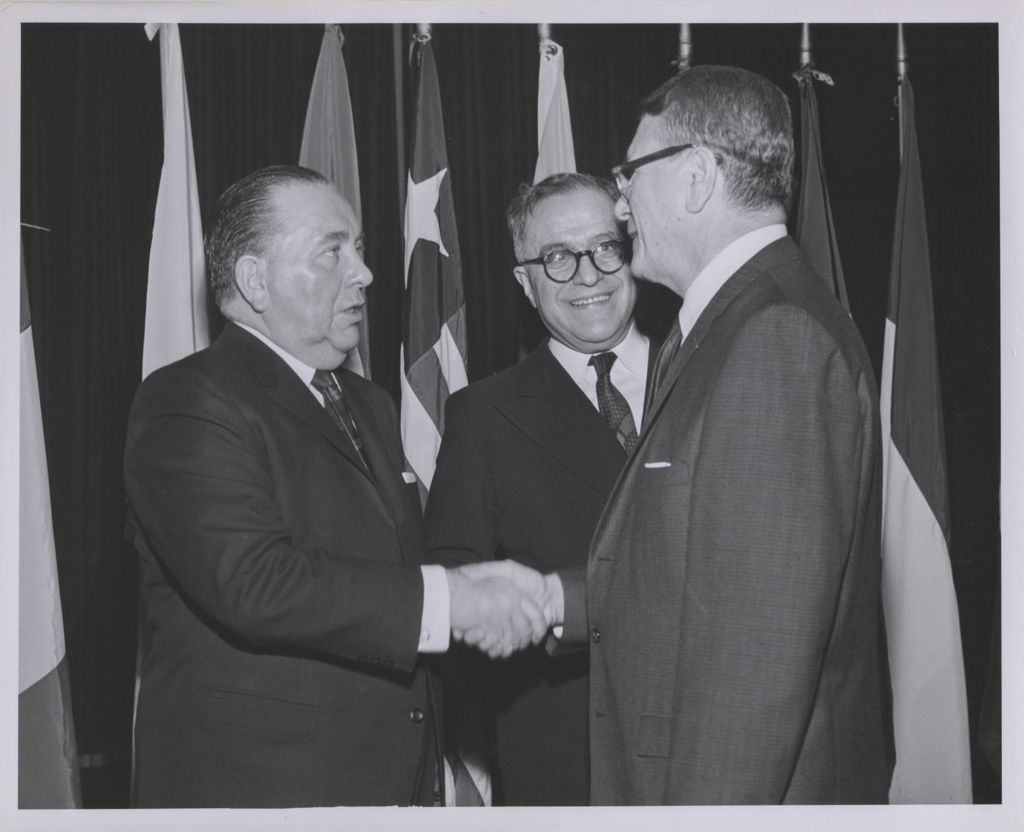 Consular Corps Reception, Richard J. Daley shakes hands with a man
