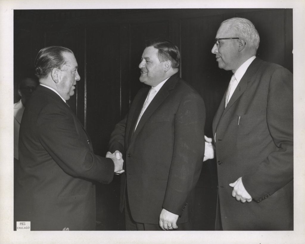 Richard J. Daley shaking hands with a man