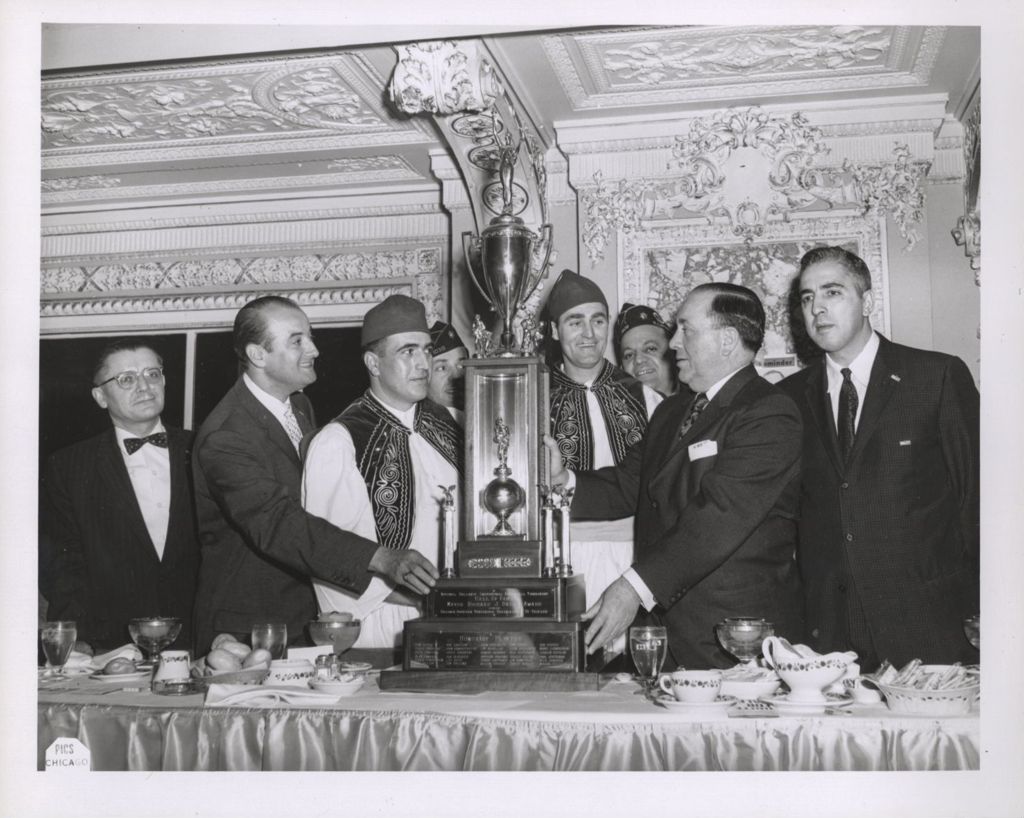 Richard J. Daley and Hellenic community members with the Mayor Richard J. Daley Award basketball trophy