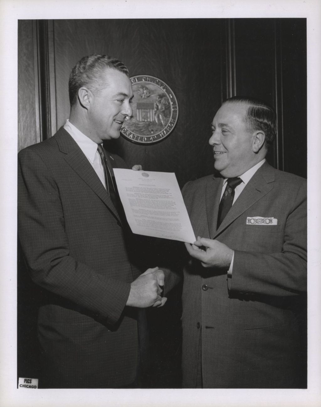 Richard J. Daley presenting a mayoral proclamation to a man