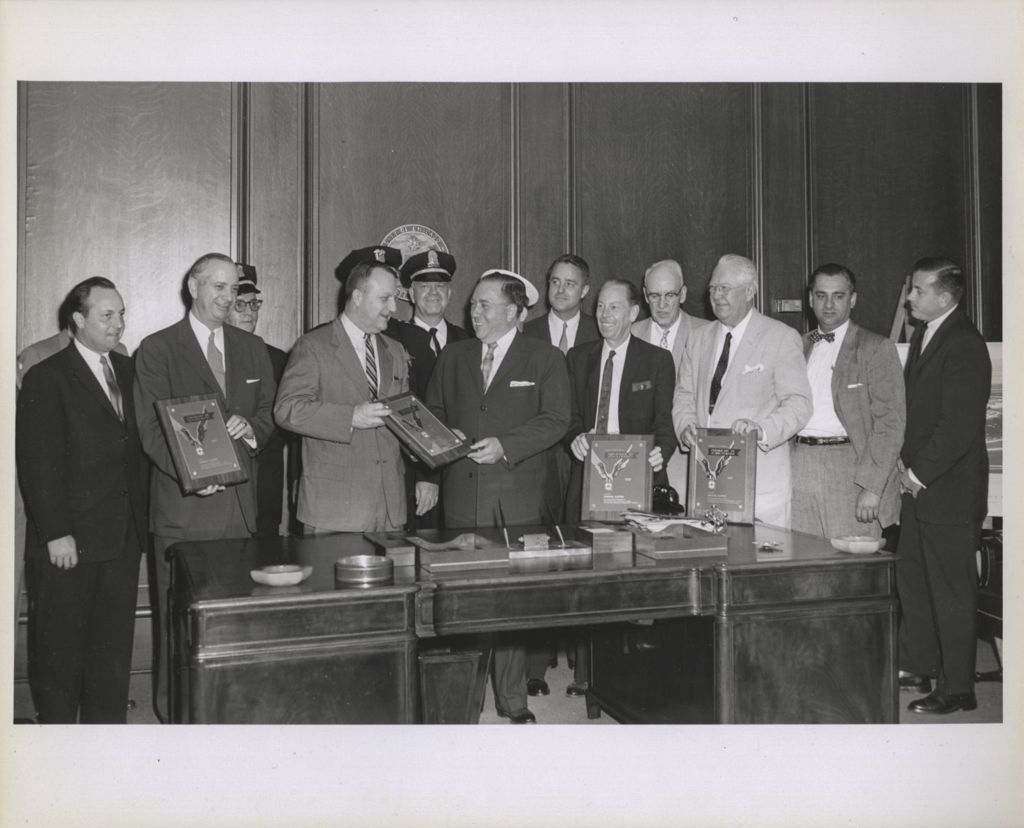 Miniature of Richard J. Daley presents awards to a group in his City Hall office