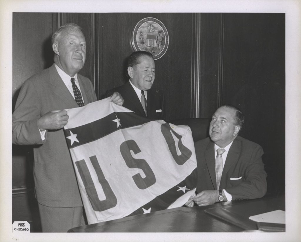 Miniature of Richard J. Daley, P.J. Cullerton and a man hold a USO flag