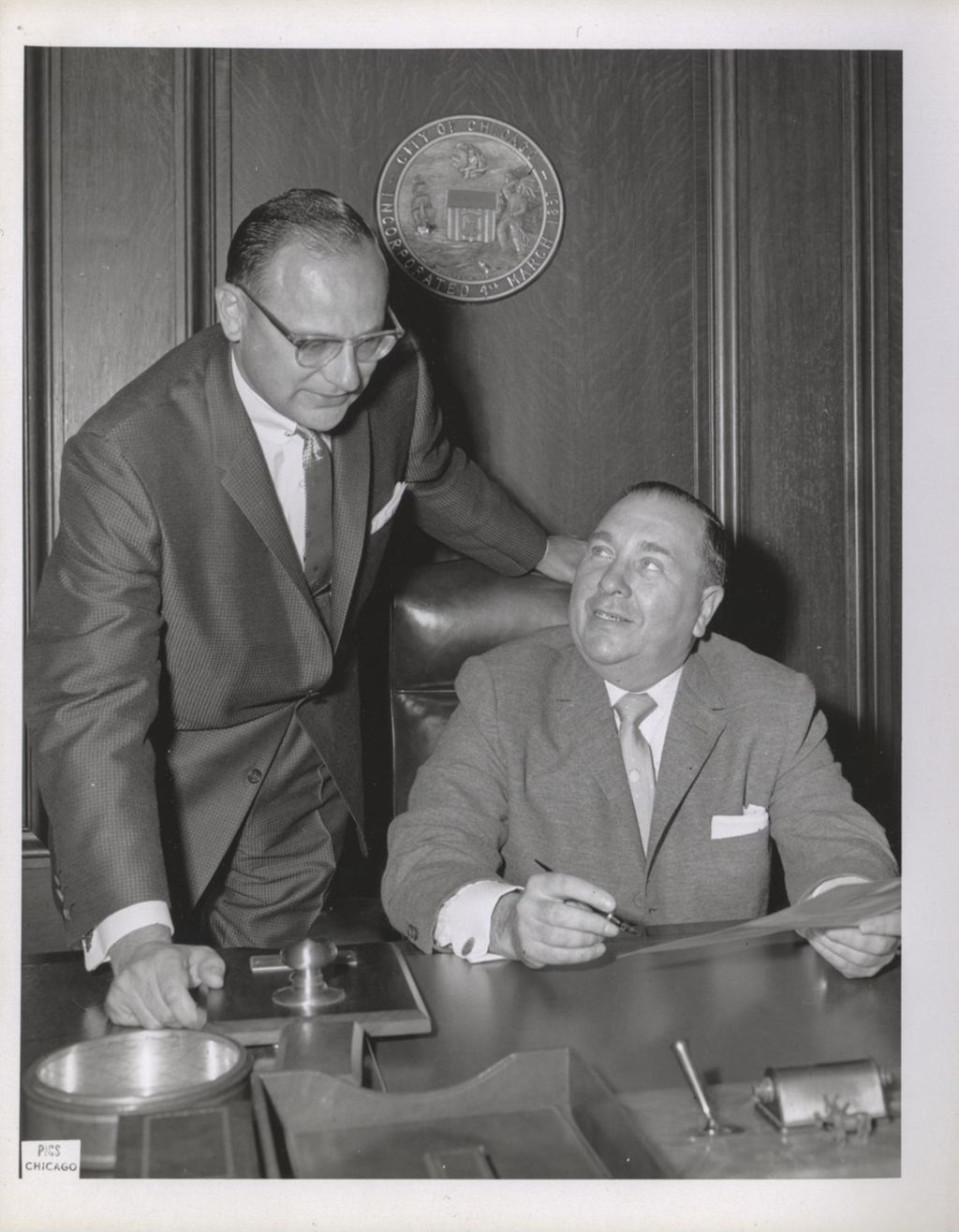 Richard J. Daley at his desk with a man next to him