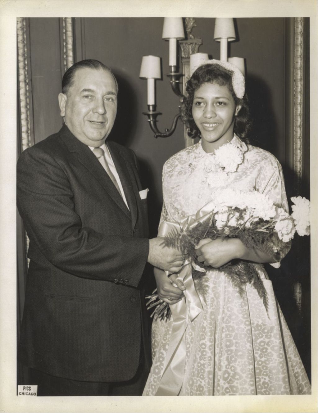 Richard J. Daley presenting flowers to an African-American woman