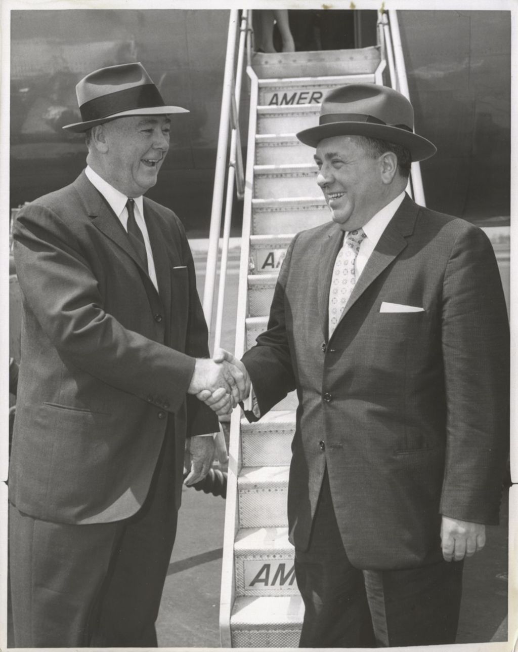 Miniature of Richard J. Daley shakes hands with Bill Lee as he boards a plane