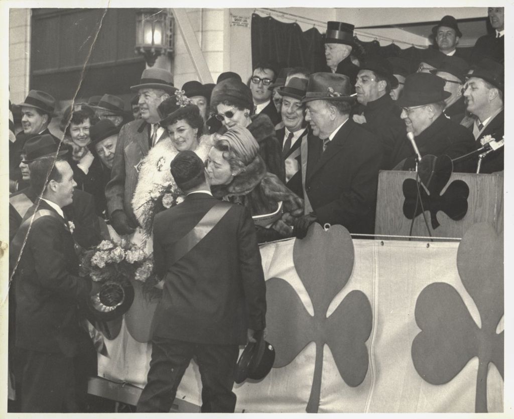 Miniature of St. Patrick's Day Parade reviewing stand, Eleanor Daley gives a kiss to her son
