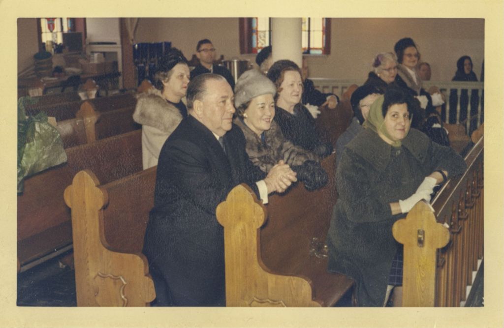 Richard J. and Eleanor Daley kneeling in a church pew