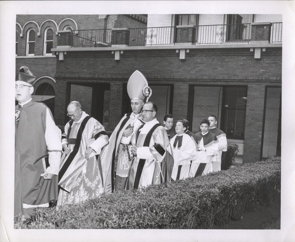 Miniature of Bishop Cletus O'Donnell and clergy in procession for Nativity of Our Lord School