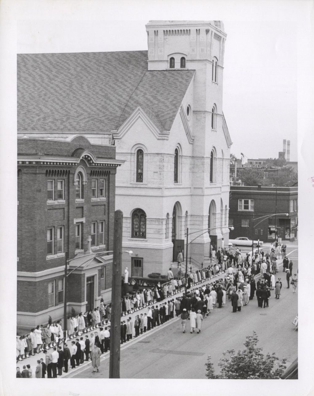 Miniature of Crowd lining the sidewalk outside of Nativity of Our Lord church