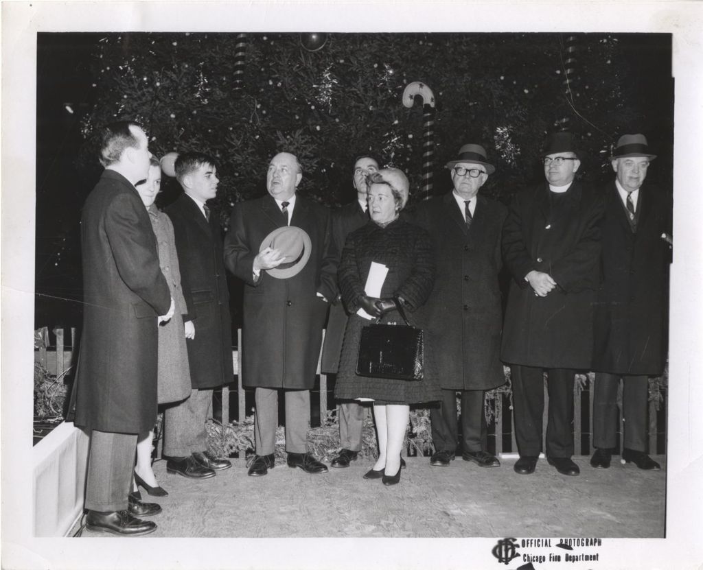 Daley family members and others in front of a Christmas tree