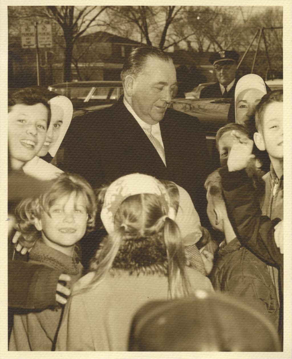Miniature of Richard J. Daley with children and nuns