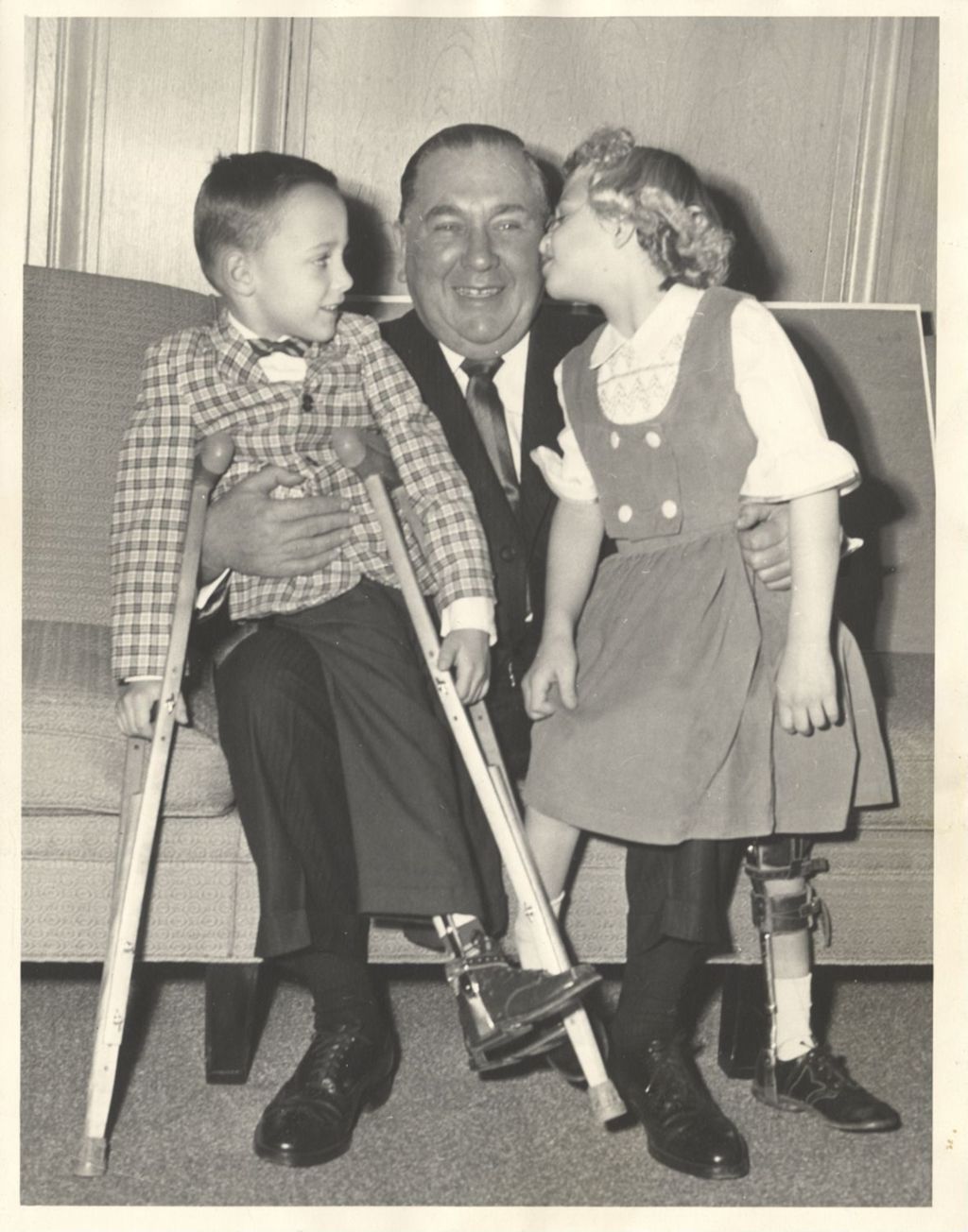Miniature of Richard J. Daley with two children wearing leg braces
