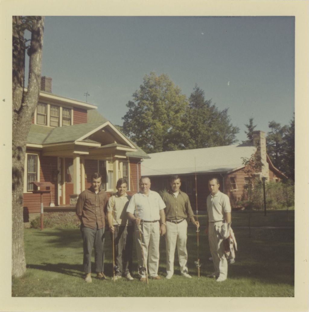 Richard J. Daley and his four sons standing outside with fishing poles