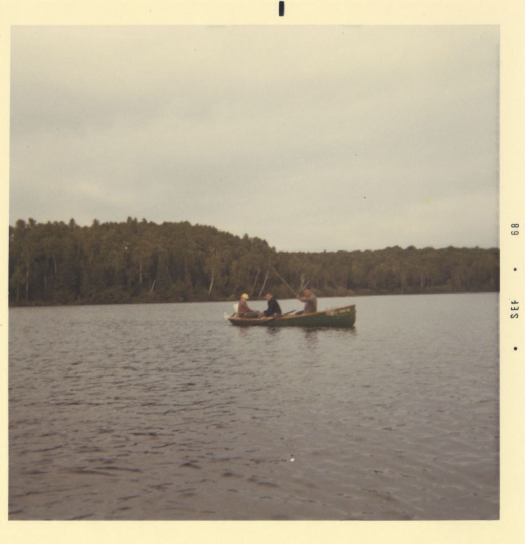 Three men fishing from a boat